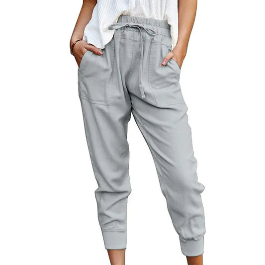 Light gray jogger pants worn by a person on a white background