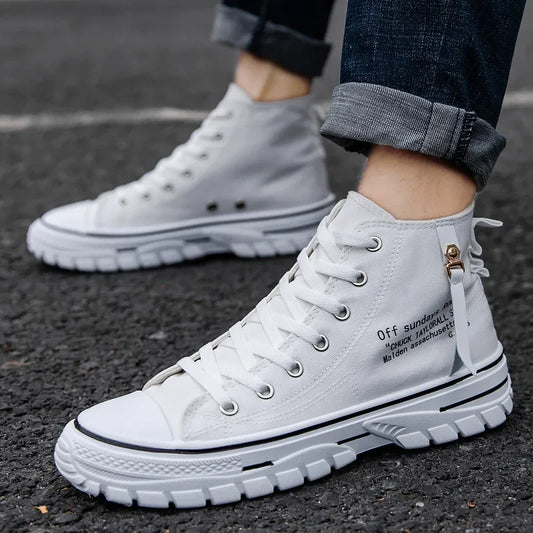 White high-top sneakers worn on a dark asphalt surface