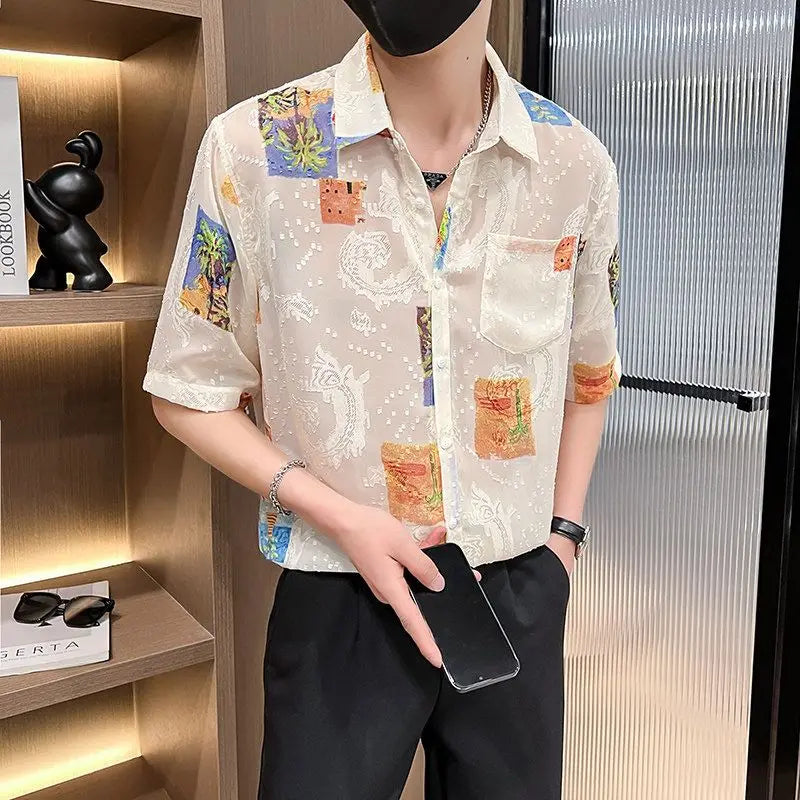 Person wearing a colorful patterned shirt holding a phone in an indoor setting.