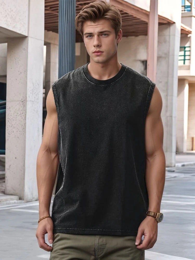 Man wearing a black sleeveless shirt and green pants standing in an urban setting.