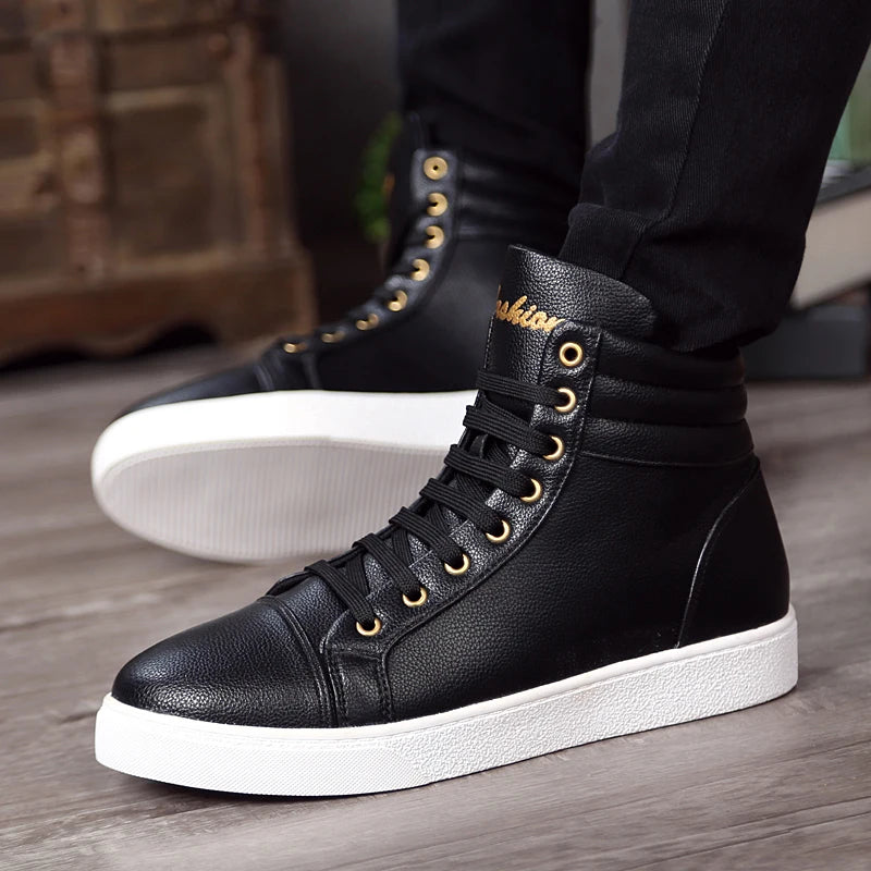 Black high-top sneakers with white soles worn by a person on a wooden floor.