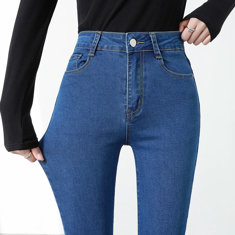 Blue jeans worn by a person on a white background