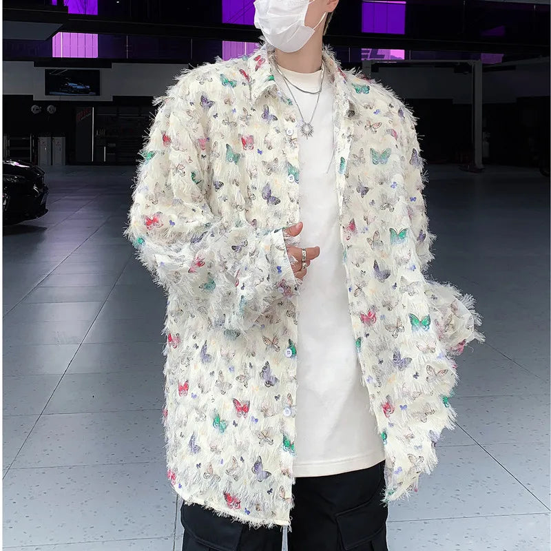 Person wearing a white coat with colorful butterfly patterns in an indoor setting.