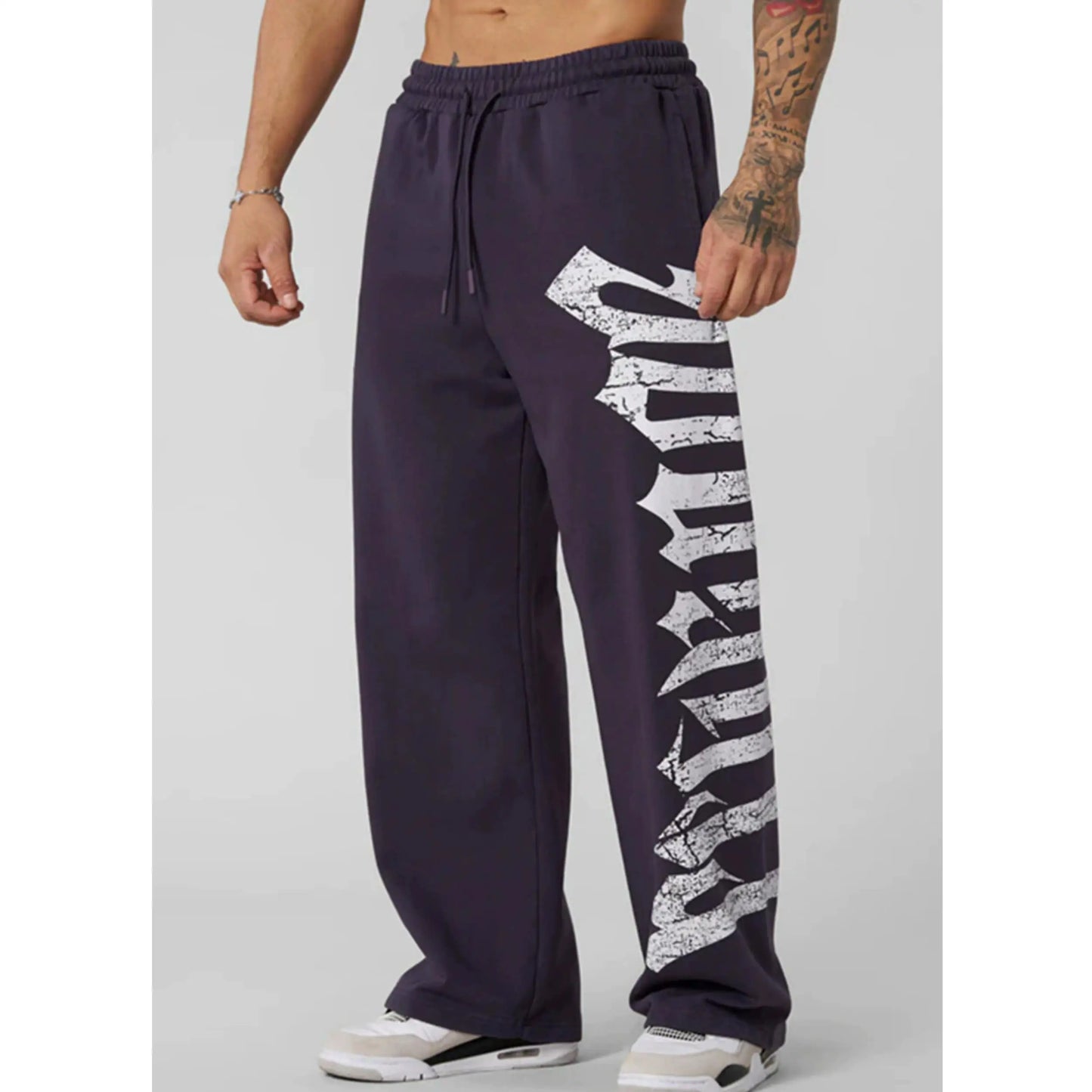 Navy sweatpants with a white graphic design on a gray background