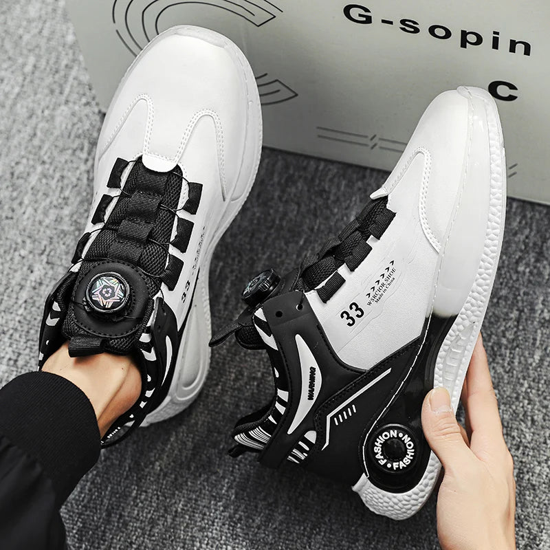 White and black sneakers with unique design elements held by a person, with a box labeled 'G-sopin' in the background.