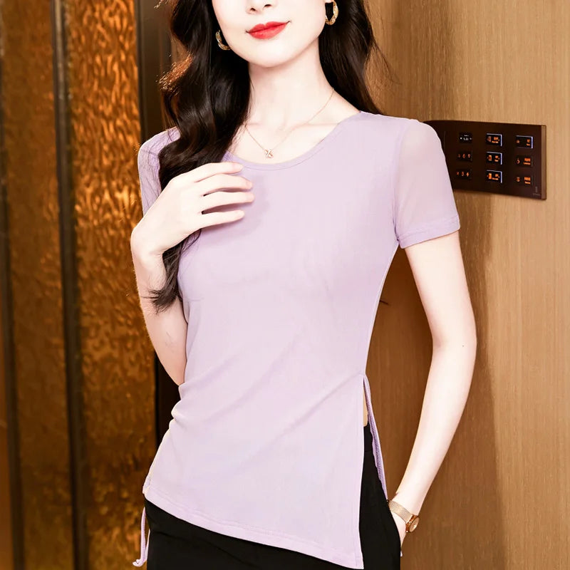 Woman wearing a light purple top with a wooden background