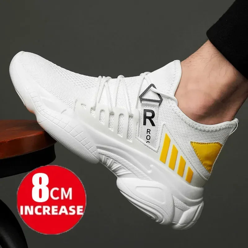 White sneaker with yellow accents worn by a person, on a dark background
