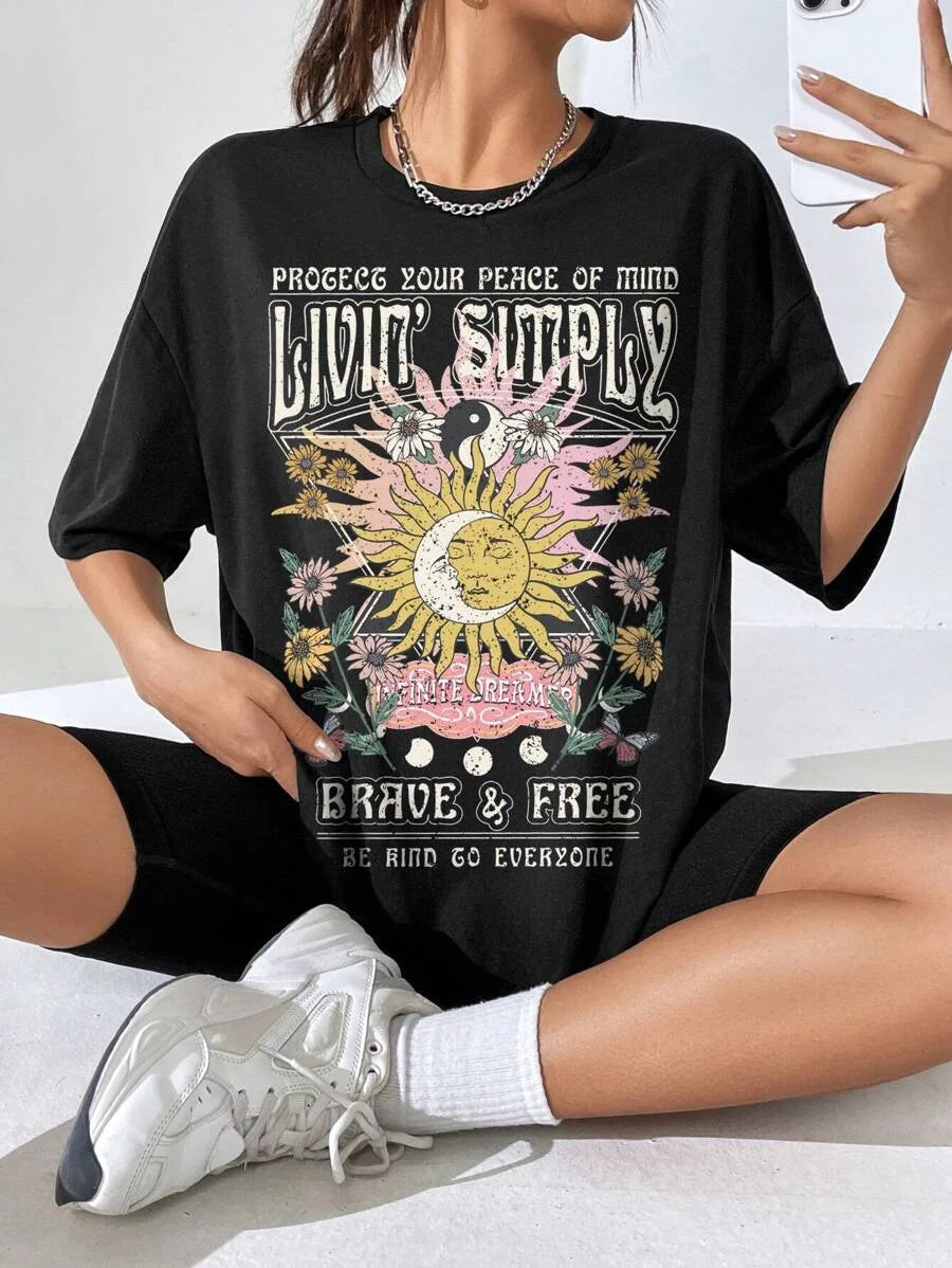 Person wearing a black t-shirt with a graphic design and text.