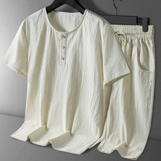White shirt and pants set on a hanger against a gray background