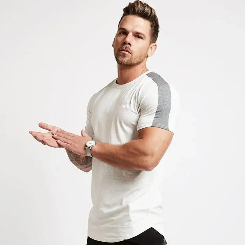 Man wearing a white and gray t-shirt on a plain background