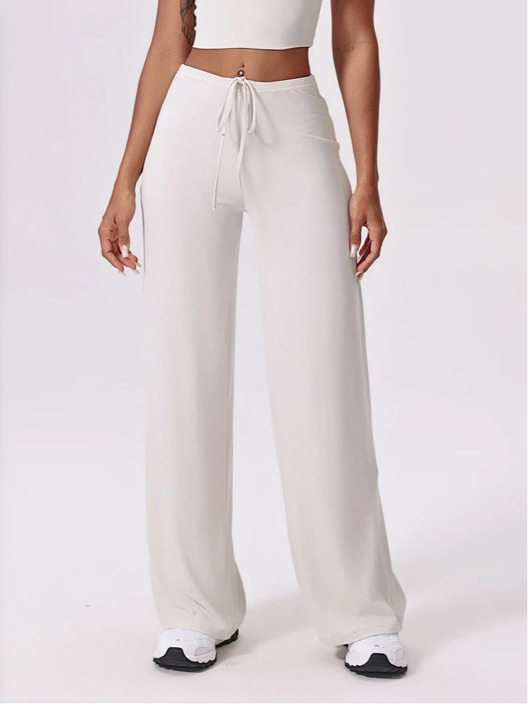 White wide-leg pants worn by a person on a white background