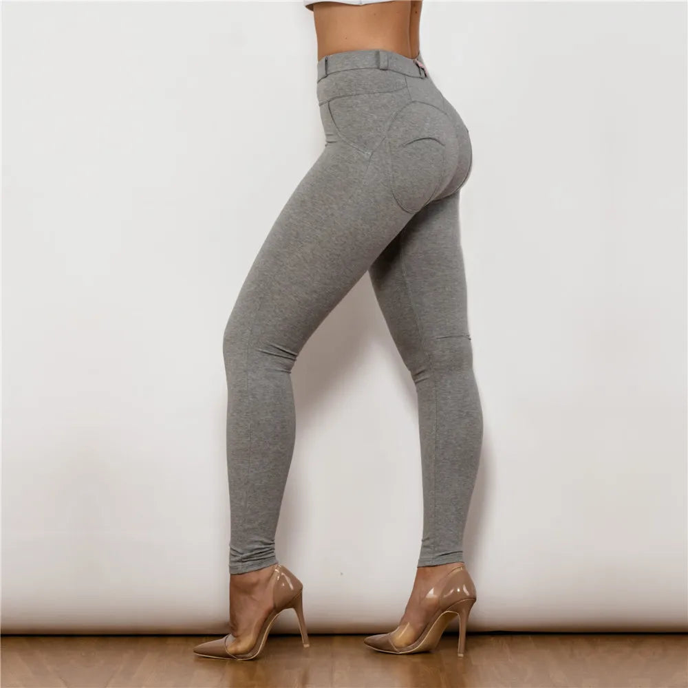 Gray leggings worn by a person on a plain background