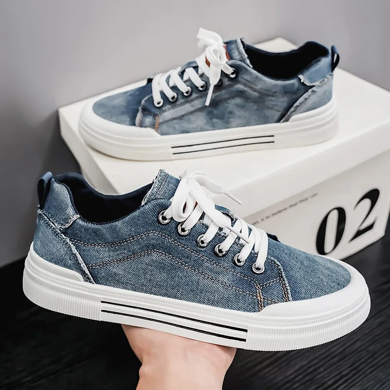 Blue denim sneakers with white soles on a dark surface