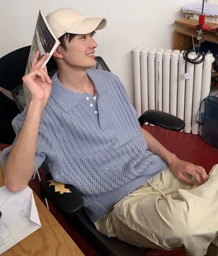 Person sitting in a room with a desk and radiator visible