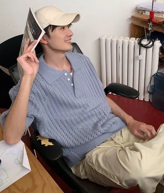 Person sitting in a room with a desk and radiator visible