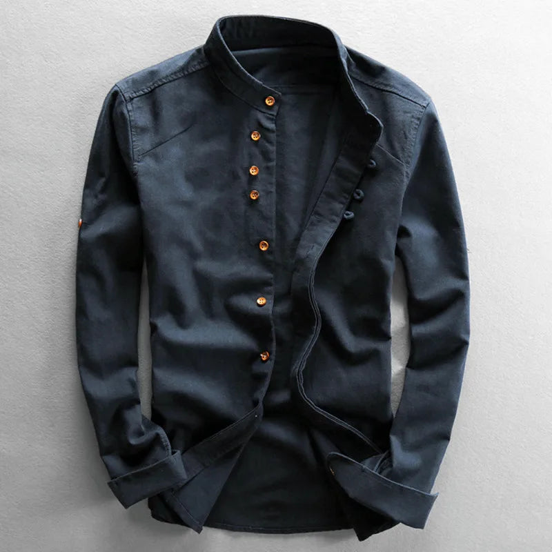Dark blue shirt with orange buttons on a light gray background