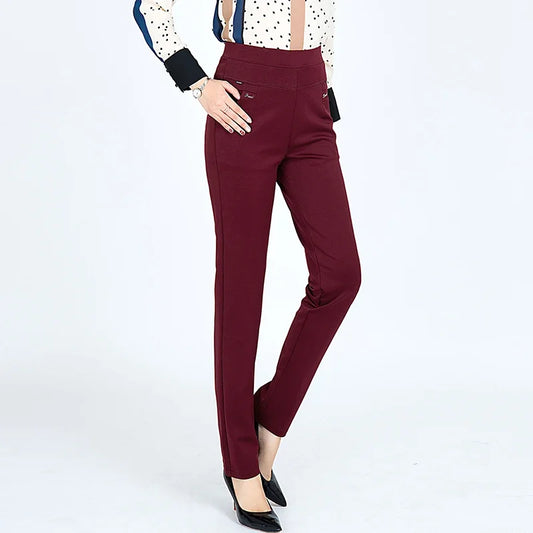 Maroon pants worn by a person on a white background