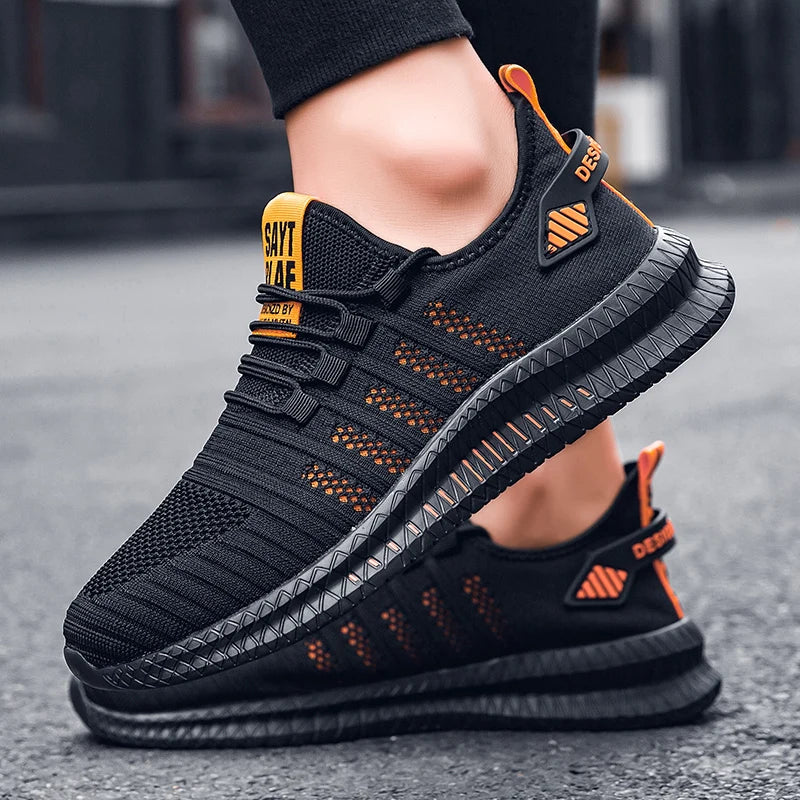 Black and orange athletic shoes on a blurred street background