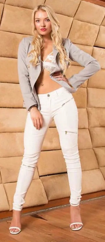 Woman wearing white jeans with a close-up of the same jeans on a beige background