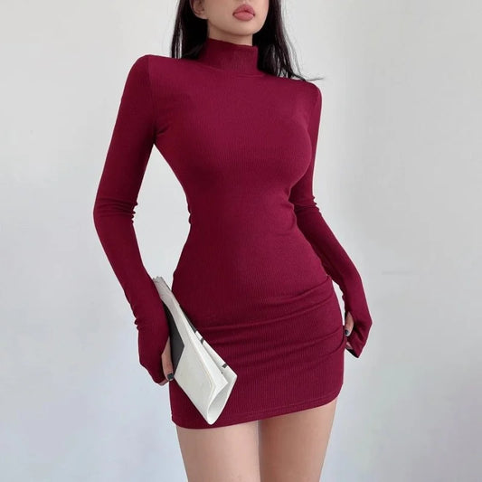 Maroon dress worn by a person on a plain background