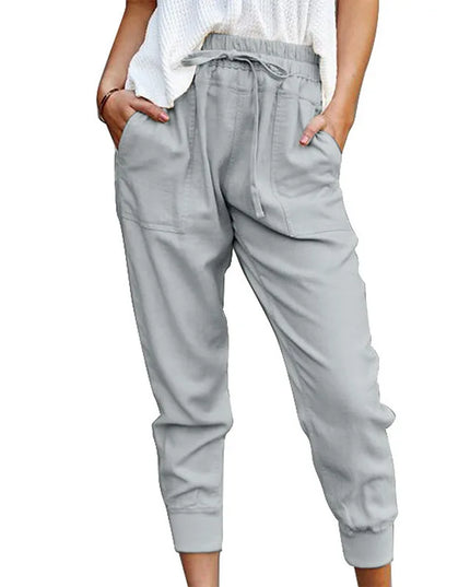 Light gray jogger pants worn by a person on a white background