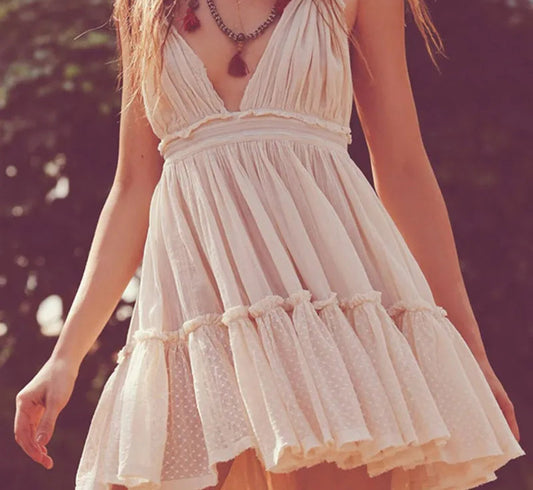 Woman wearing a light-colored dress with a blurred background