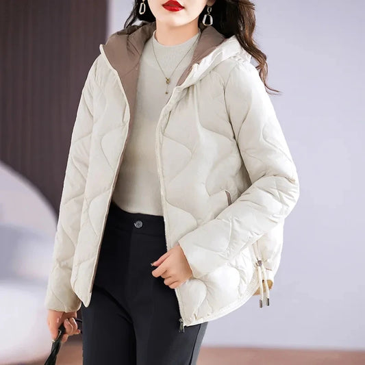 Woman wearing a light-colored puffer jacket with a blurred background
