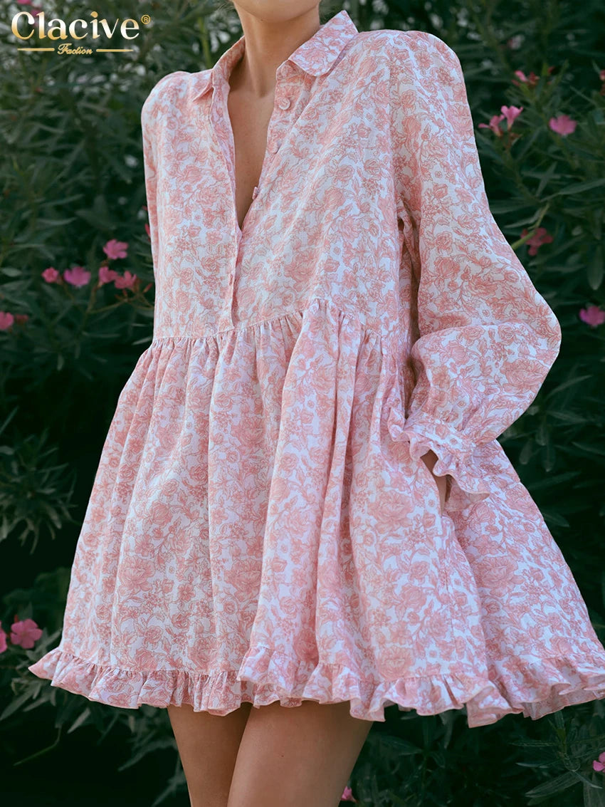Pink floral dress worn by a person with green foliage and flowers in the background