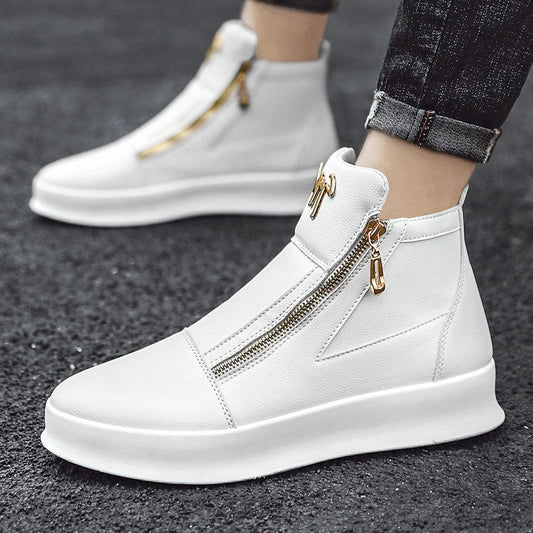 White high-top sneakers with gold zippers worn by a person on a dark surface