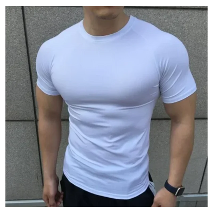 Person wearing a white t-shirt against a gray wall