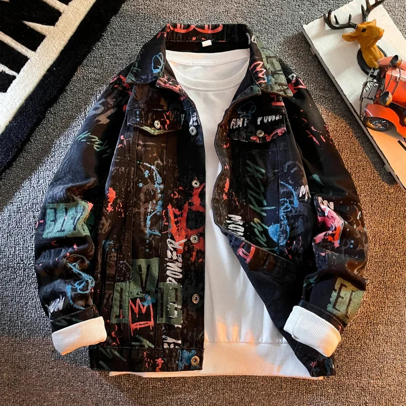 Colorful jacket with graphic designs on a white shirt, placed on a textured surface.