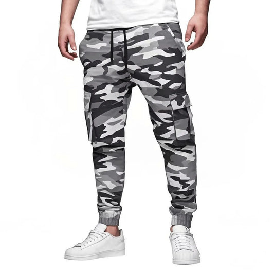 Camouflage pants worn by a person on a white background