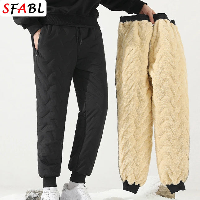 Person holding black and beige quilted pants against a white background