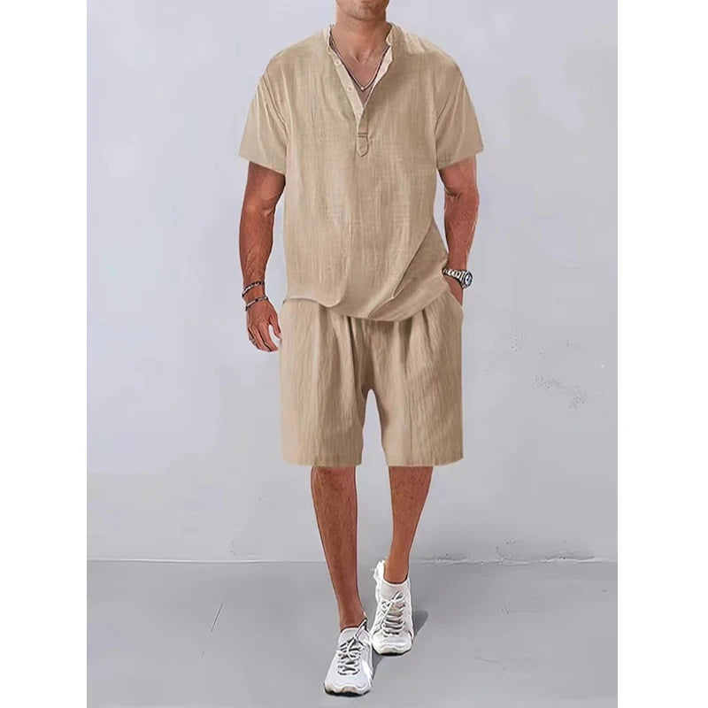 Person wearing a beige outfit with shorts and a shirt against a plain background