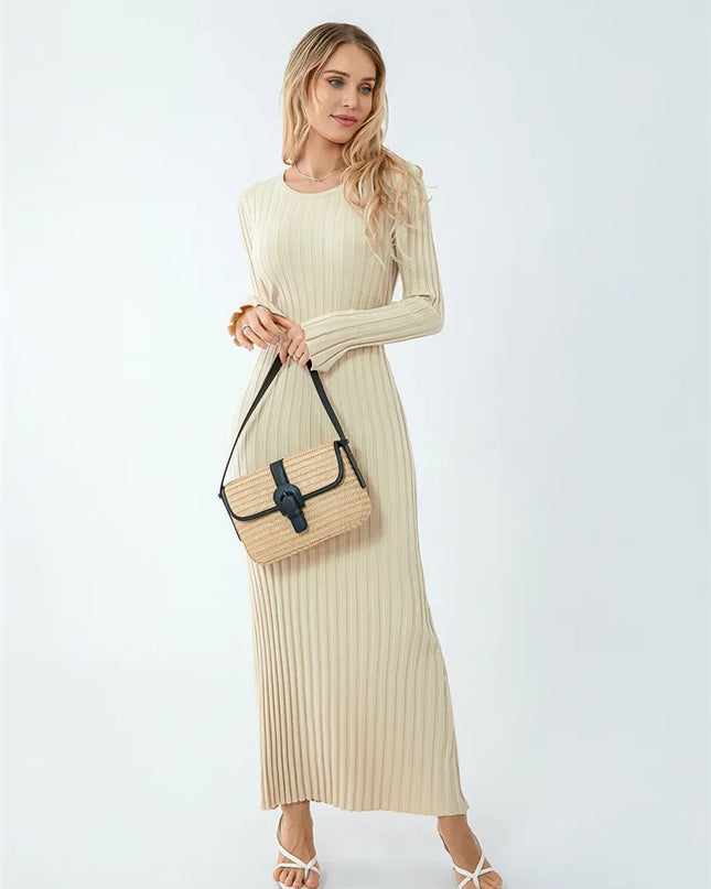 Woman wearing a beige ribbed dress holding a beige handbag on a white background