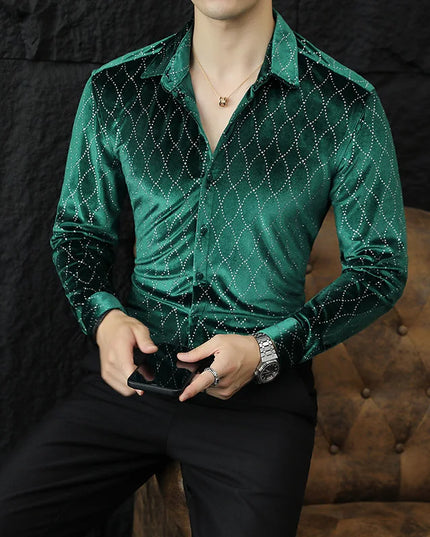 Person wearing a green velvet shirt with a pattern, sitting on a brown leather couch.