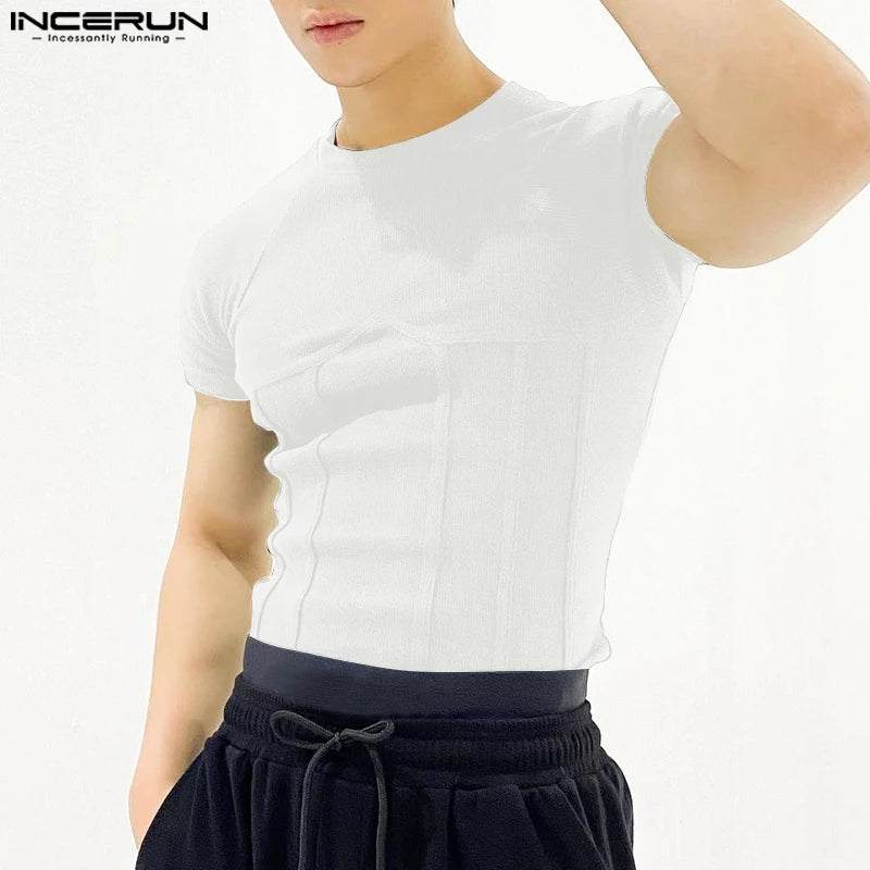 Person wearing a white t-shirt and black pants on a white background