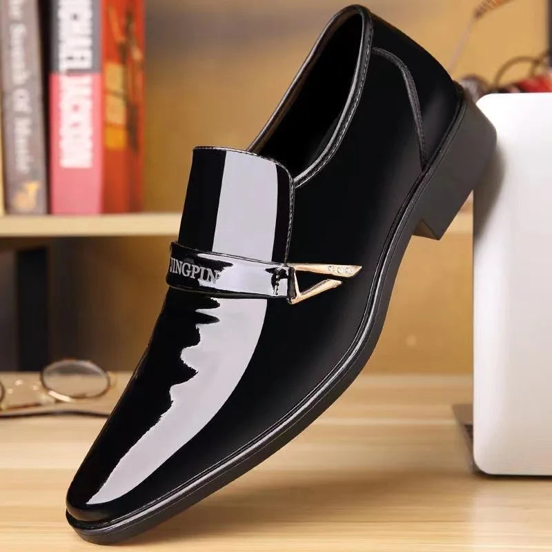 Black patent leather shoe with a gold buckle on a wooden surface.