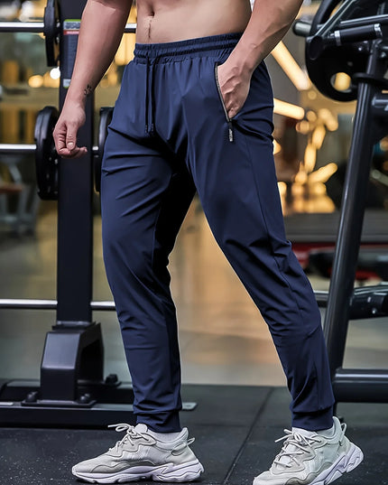 Person wearing navy blue athletic pants and white sneakers in a gym setting