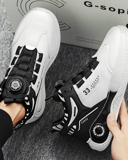 White and black sneakers with unique design elements held by a person, with a box labeled 'G-sopin' in the background.