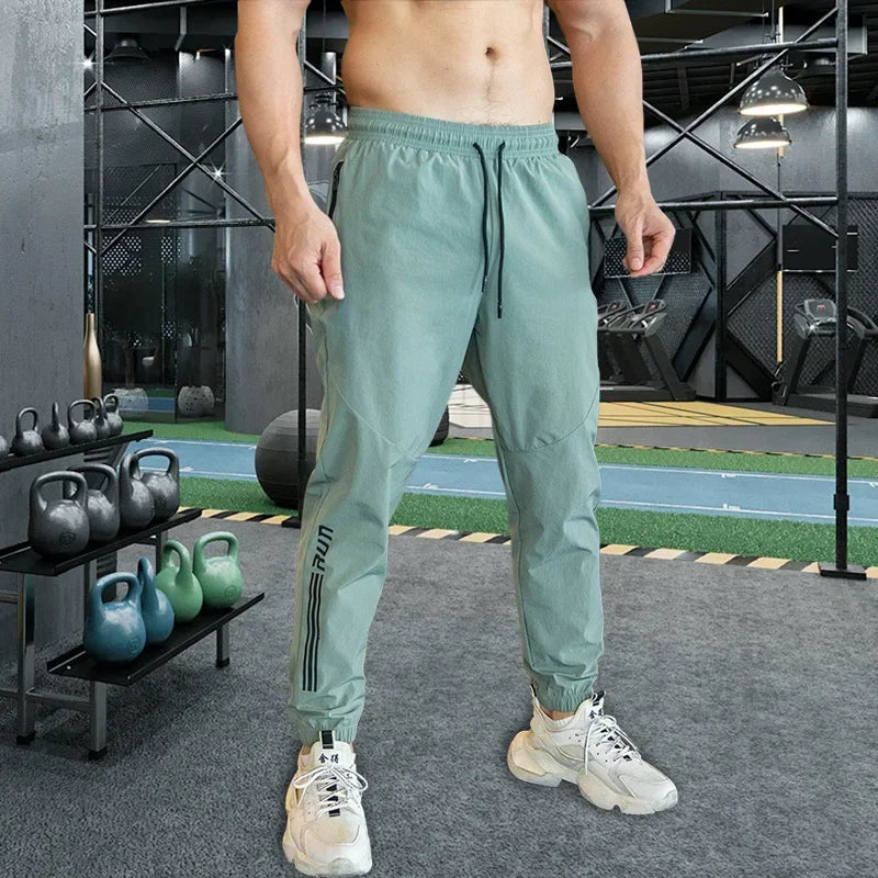 Person wearing light green athletic pants in a gym setting