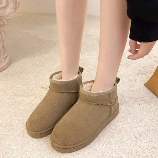 Brown suede boots with fur lining worn indoors on a light carpet.