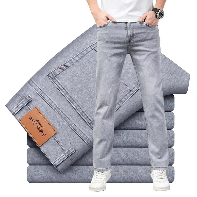 Stack of light gray jeans with a person wearing one, on a white background