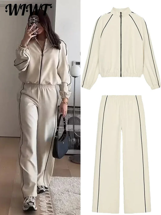 Woman taking a mirror selfie wearing a cream-colored tracksuit with black accents, with an inset showing the outfit details.