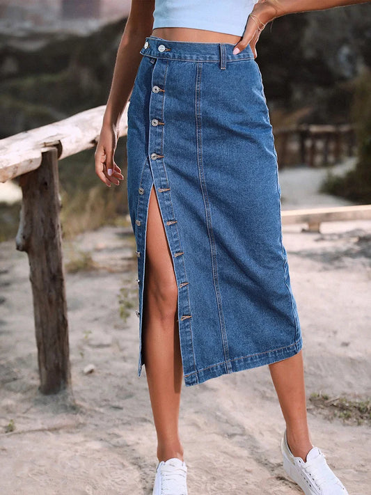 Person wearing a blue denim skirt with a blurred natural background