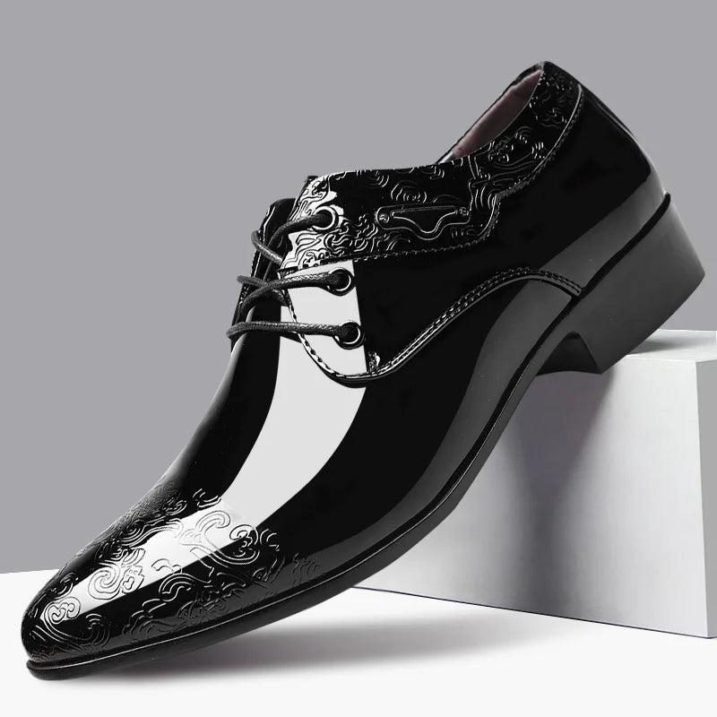 Black dress shoe with intricate design on a gray background
