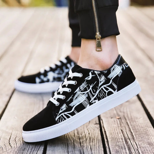 Black sneakers with white patterns on a wooden floor