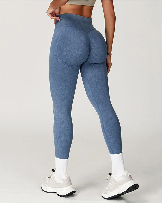 Person wearing blue leggings on a plain background