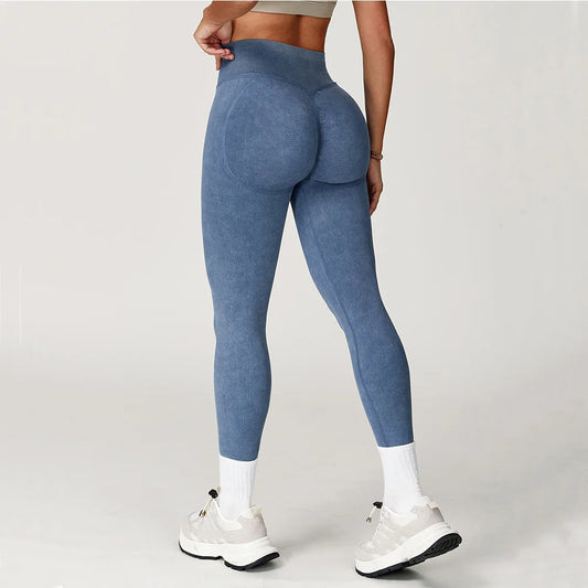Person wearing blue leggings on a plain background