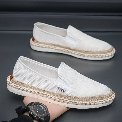 White loafers with woven sole on a dark background